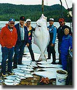 Happy guests with their day's catch of halibut, crabs, and salmon.